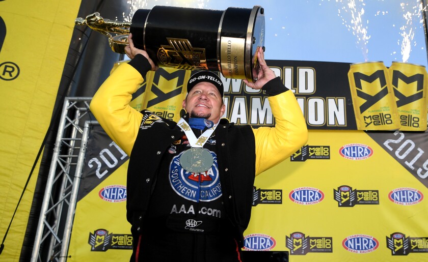 Funny car champion Robert Hight celebrates at Auto Club Raceway in Pomona on Sunday.