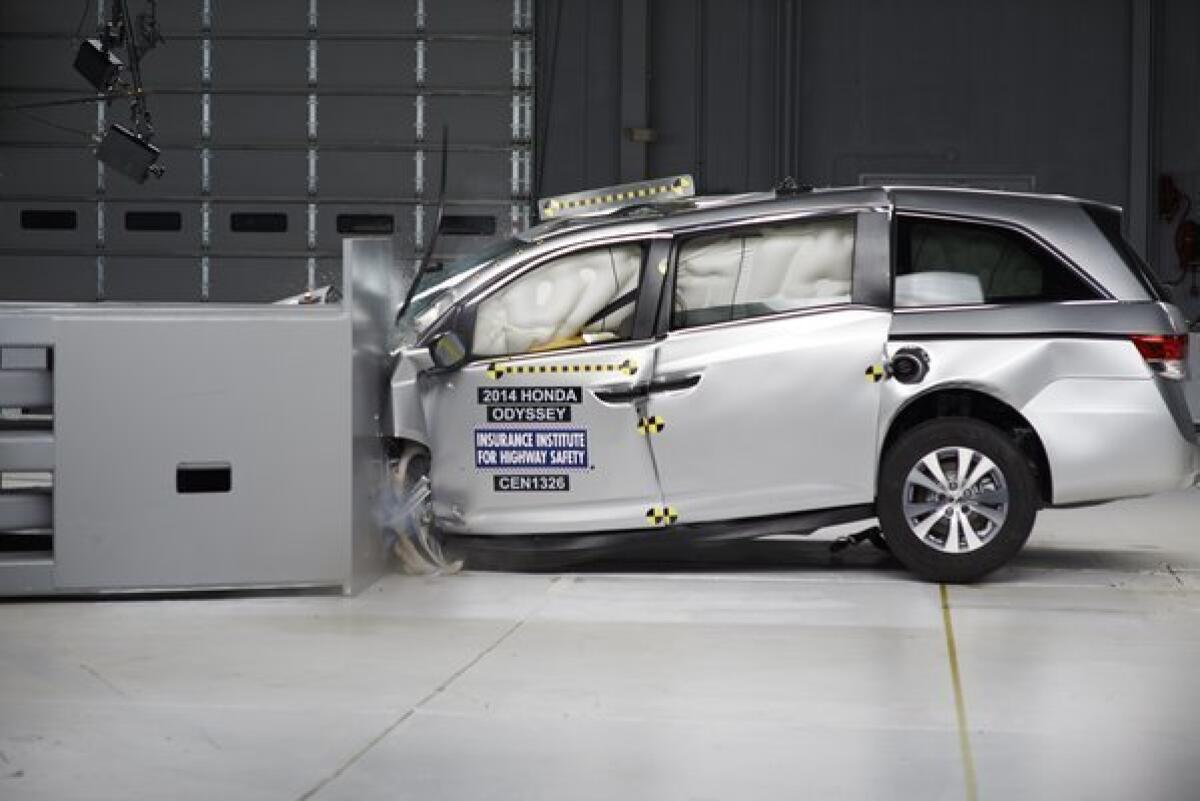 The 2014 Honda Odyssey is tested during the Insurance Institute for Highway Safety's small overlap frontal crash test.