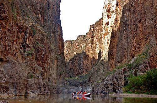Rafters on the Rio Grande make their way through the rocky cliffs of Big Bend National Park in Texas. The park's remote location and infernally hot summers make it one of the system's least visited sites, despite its craggy beauty and scenic views. The shallow waters of the Rio Grande make for a placid journey through miles of river rafting.