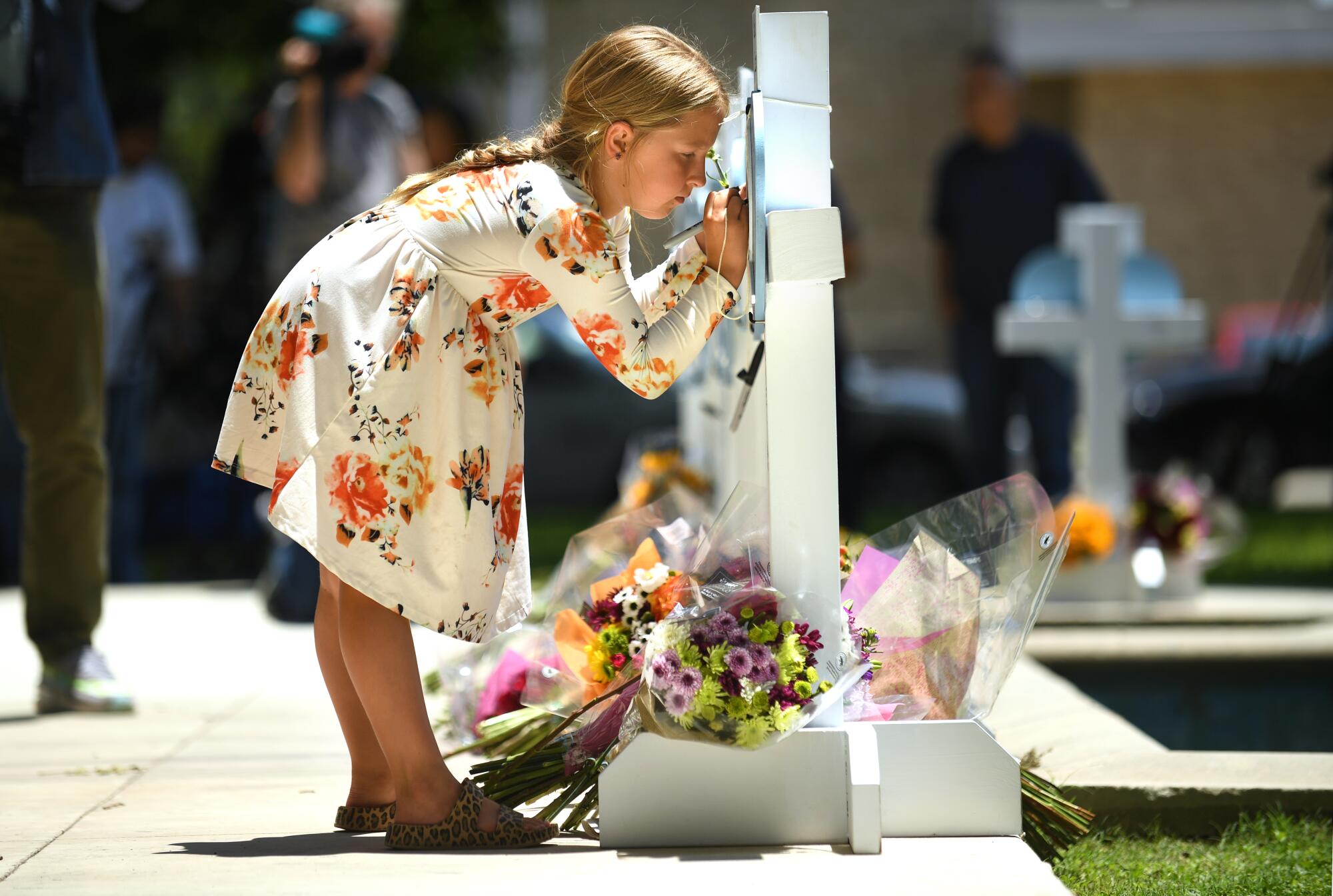 Kymber Guzman, 8, signs a memorial for the victims of the school shooting in Uvalde, Texas. 