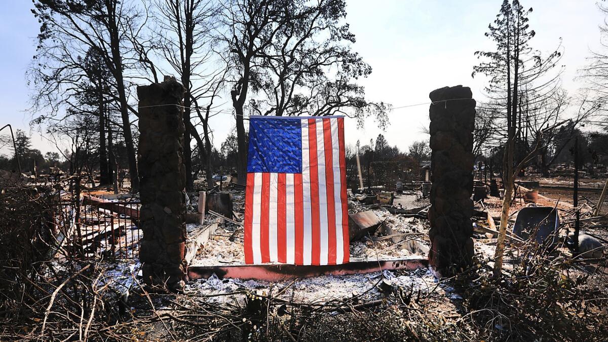On Willowview Court in Santa Rosa, a homeowner displays an American flag amidst the destruction from the wildfire.