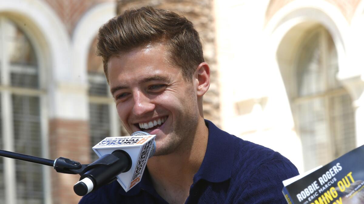 L.A. Galaxy midfielder Robbie Rogers, author of "Coming Out to Play," laughs while being interviewed by Times columnist Chris Erskine at the Los Angeles Times Festival of Books at USC on Sunday.