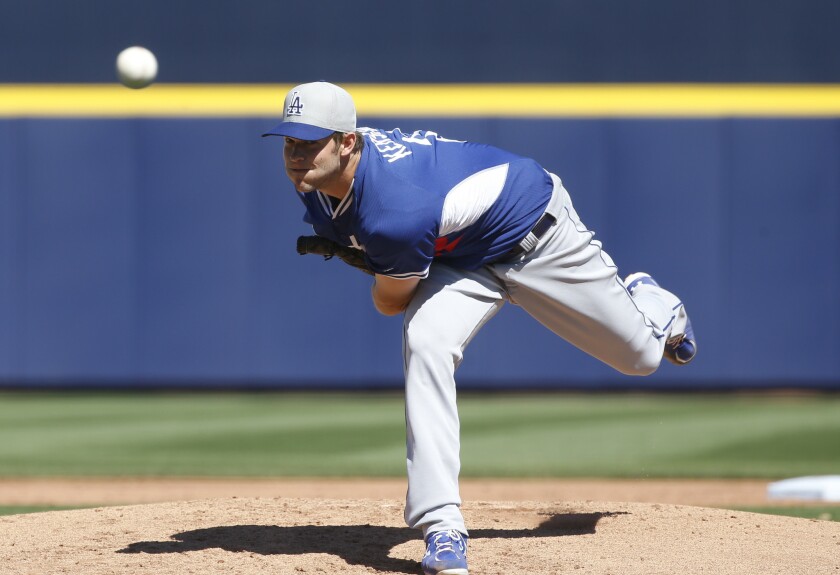 Dodgers left-handed pitcher Clayton Kershaw delivers against the Mariners in a spring training game.
