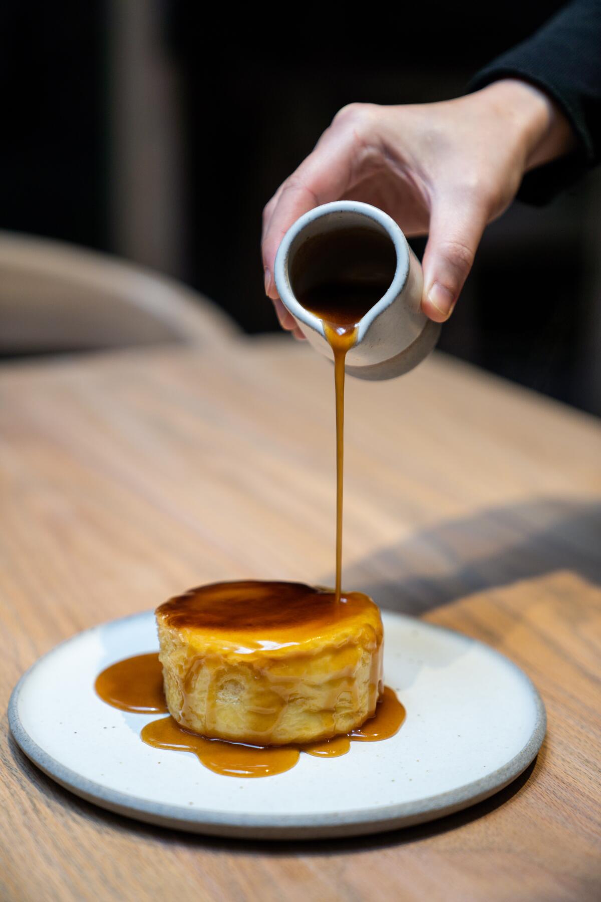LOS ANGELES, CA - MARCH 14: Pastry Chef Dyan Ng pours the honey butter over the brioche as she makes a pan roasted honey butter Brioche in the kitchen at Auburn on Saturday, March 14, 2020 in Los Angeles, CA. (Kent Nishimura / Los Angeles Times)