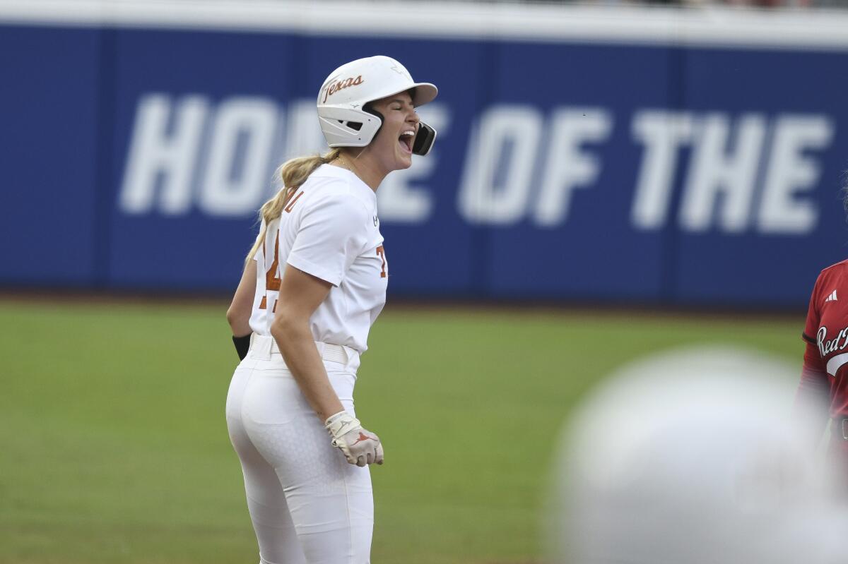 Reese Atwood celebrates after Texas scores a run against Texas Tech in Game 3 of the Women's College World Series.