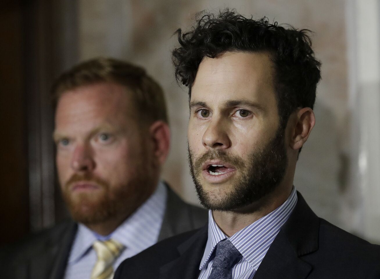 Attorneys Tyler Smith, right, and Curtis Briggs, who represent Max Harris, speak to reporters at a courthouse in Oakland.