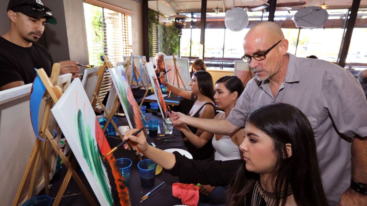 Artist Al Scholl offers pointers to students in his Art Therapy class at the Inland Tavern in San Marcos on Jan. 20.