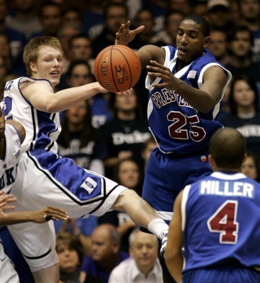 Duke's Kyle Singler, left, and Presbyterian's Aaron Gibbs (25) battle for a rebound during the first half of an NCAA college basketball game in Durham, N.C., Monday, Nov. 10, 2008. (AP Photo/Gerry Broome)