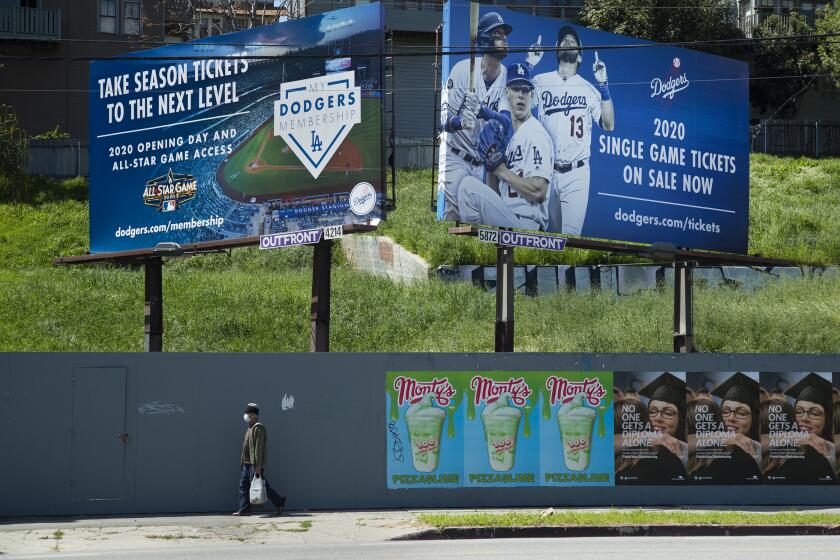 LOS ANGELES, CA-MARCH 26, 2020: Signs on Sunset Blvd. near the entrance to Dodger Stadium advertise season tickets and individual game tickets. March 26, 2020 would have been opening day if not for the coronavirus outbreak. (Mel Melcon/Los Angeles Times)