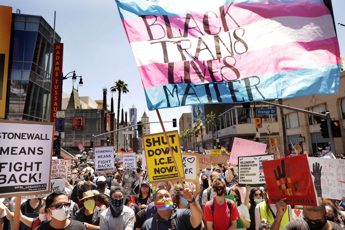 A protester's flag carries the message "Black Trans Lives Matter" in Sunday's demonstration in Hollywood.