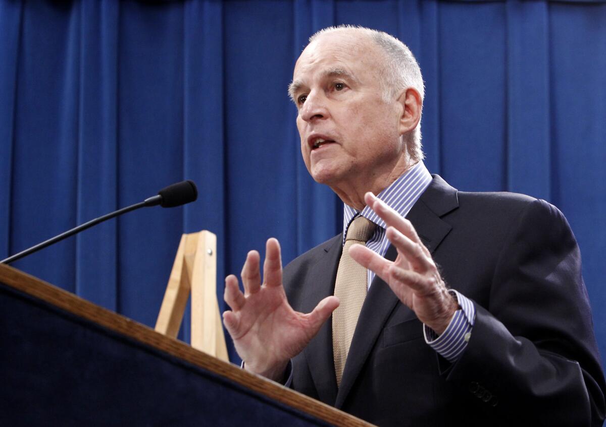 Gov. Jerry Brown responds to a question at a May news conference in Sacramento. Brown signed a new contract with California's largest state worker union on Thursday, granting raises to more than 90,000 employees.