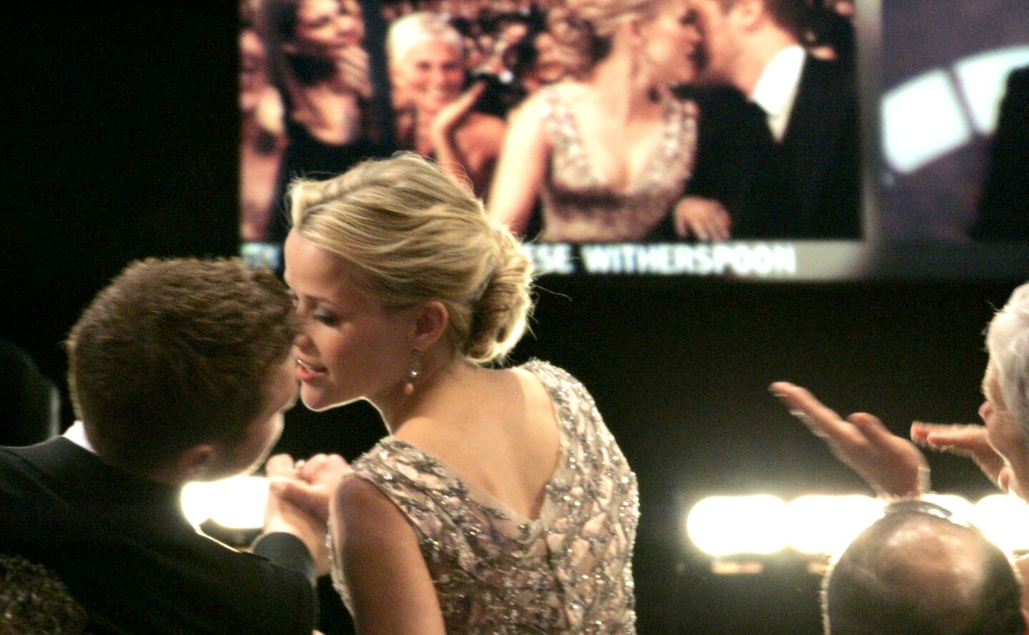Reese Witherspoon kisses her then-husband, Ryan Phillippe, after hearing her name announced as the lead actress winner for "Walk the Line," during the 78th Academy Awards.