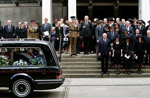 The hearse carrying the coffin of British Army Lt. Col. Rupert Thorneloe leaves the Guards Chapel in London. On the first step, from left, are Thorneloe's father, John, a retired army major; wife, Sally; mother, Veronica; and sister, Sally.