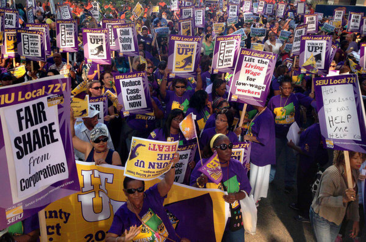 Los Angeles County workers with SEIU Local 721 march for higher wages.