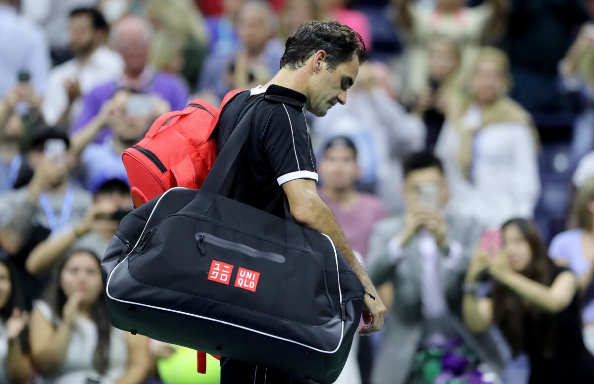 Roger Federer walks off the court after losing to Grigor Dimitrov during the U.S. Open quarterfinals on Tuesday.