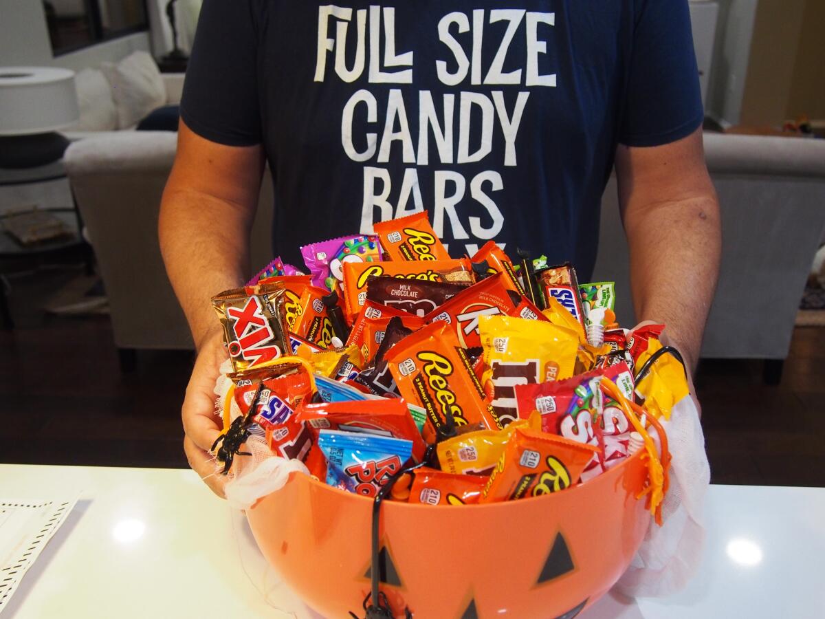 A jack-o-lantern container filled with full-size candy.