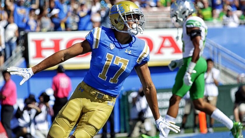 UCLA receiver Christian Pabico celebrates after scoring a touchdown against Oregon during the first quarter Saturday.