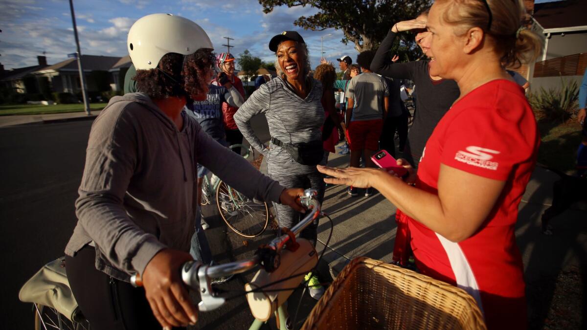 From left, neighbors Diane Robertson, Carole Gillie and Sandy Zalagens chat before they begin a walk together in Leimert Park.