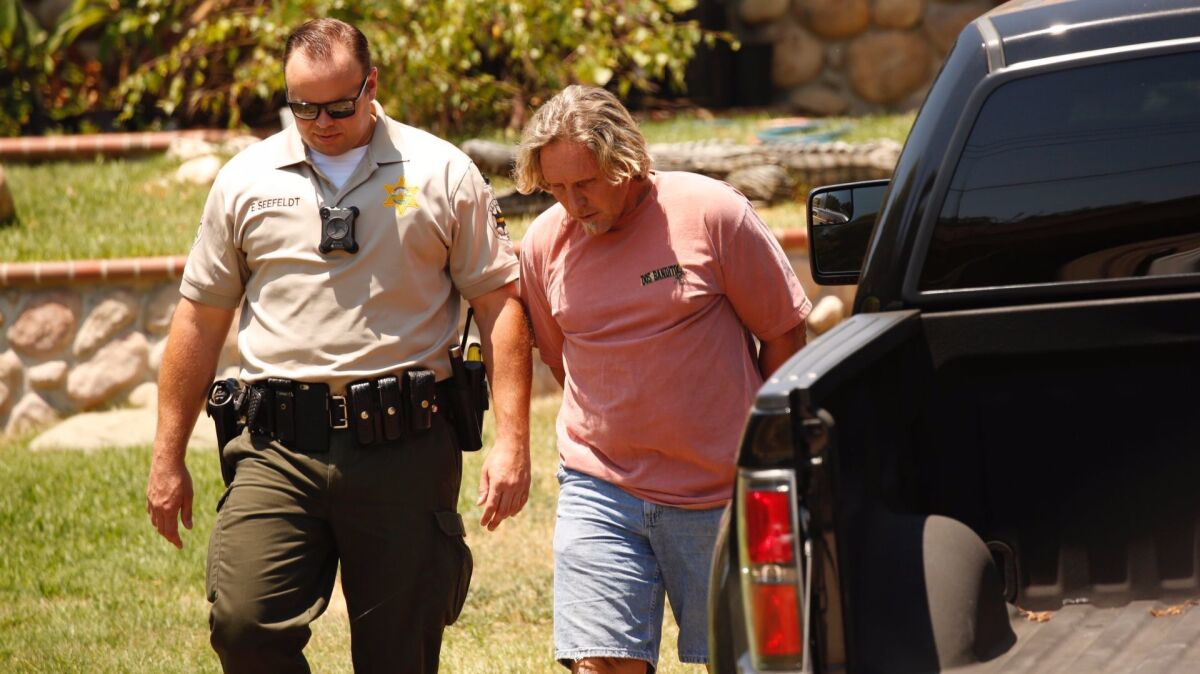 Ventura County sheriff's deputies arrest Todd Kates as authorities collect American alligators and a number of snakes, some venomous, at a Thousand Oaks home.