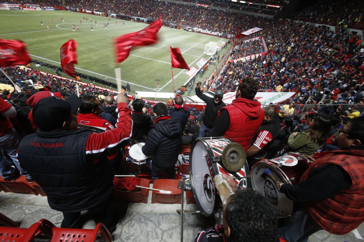 Mexican soccer wave flags and cheer Club Tijuana vs. Monterrey at Caliente Stadium in 2017
