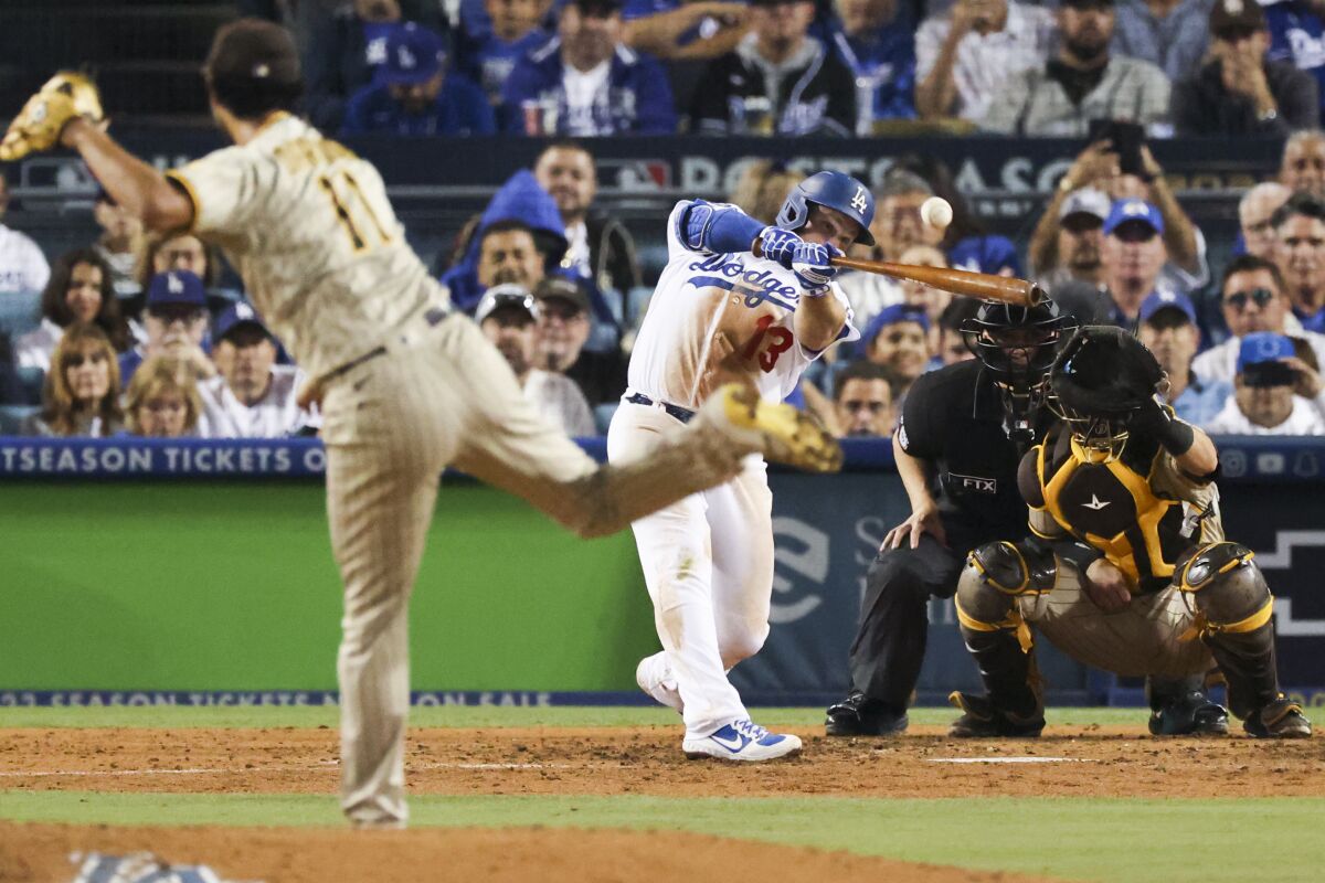 Dodgers' Max Muncy hits a single against San Diego Padres starting pitcher Yu Darvish.