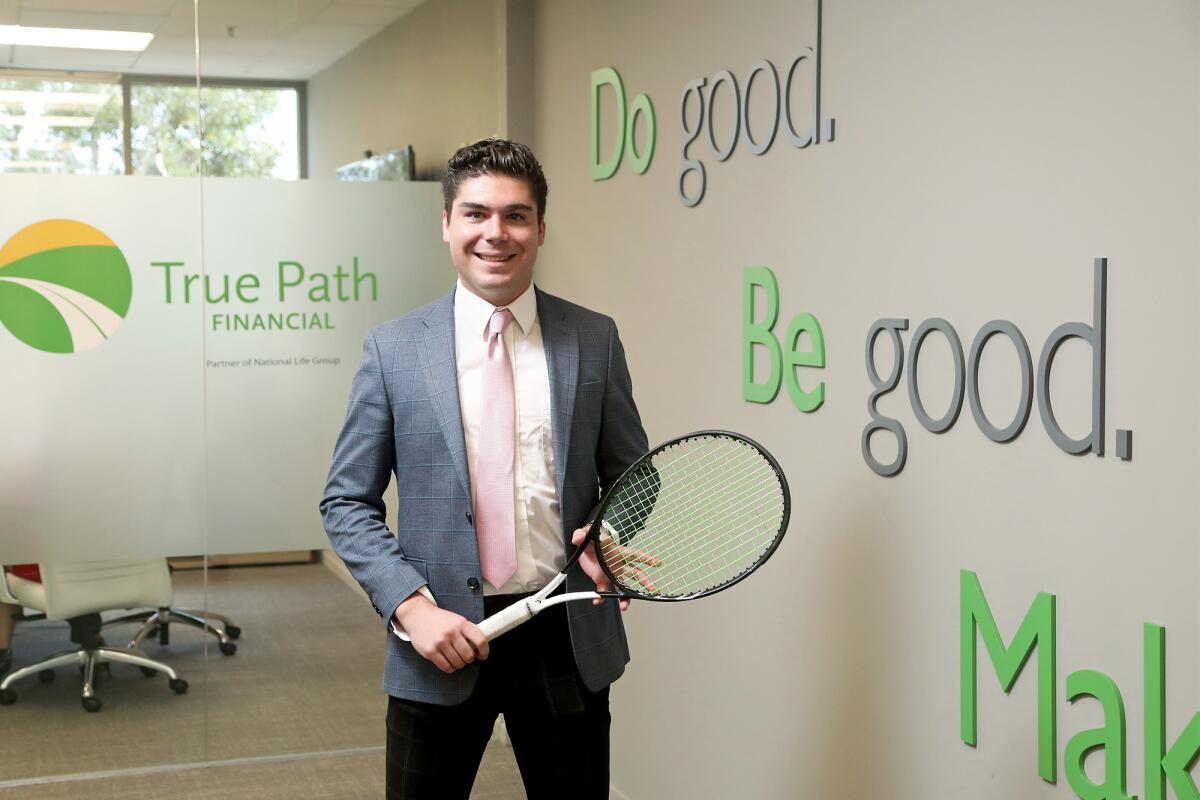 Financial advisor Joseph Di Giulio, 25, is shown in his Newport Beach office.