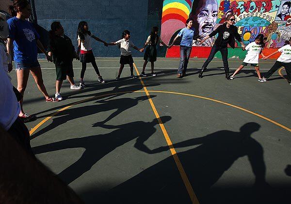 Students play "stride ball," a game popular in Australia, as part of the Just Like You sports program at Camino Nuevo Charter Academy in Los Angeles. Every Friday, students leave their world -- tiny Pico-Union apartments shared with parents and siblings -- to travel someplace new. They've voyaged across Mongolia, Beijing and Shanghai; Botswana, Malawi and Namibia, to play games that kids their own age play in those countries. See full story
