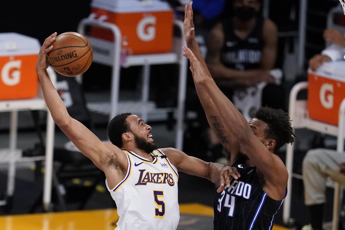 Talen Horton-Tucker is defended by Orlando Magic center Wendell Carter Jr.