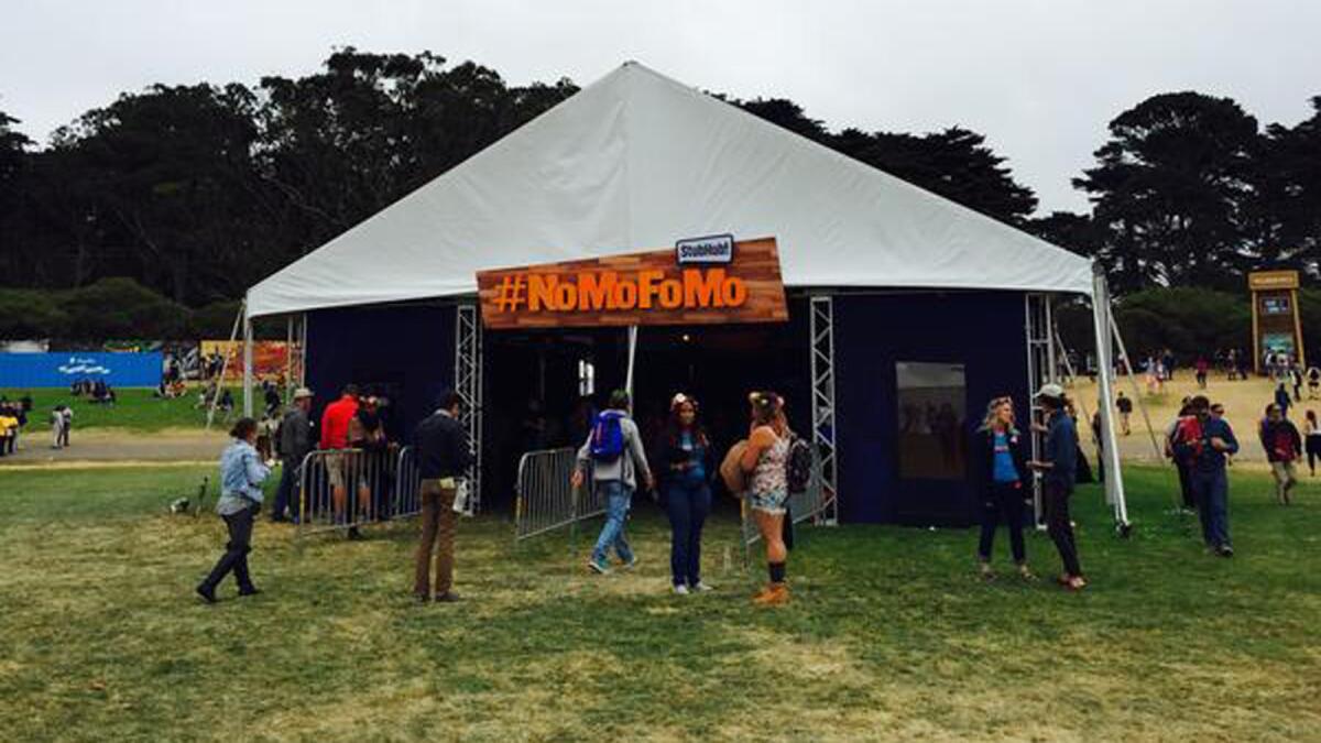 Attendees at the Outside Lands Music and Arts Festival wander into the StubHub #NoMoFoMo tent.