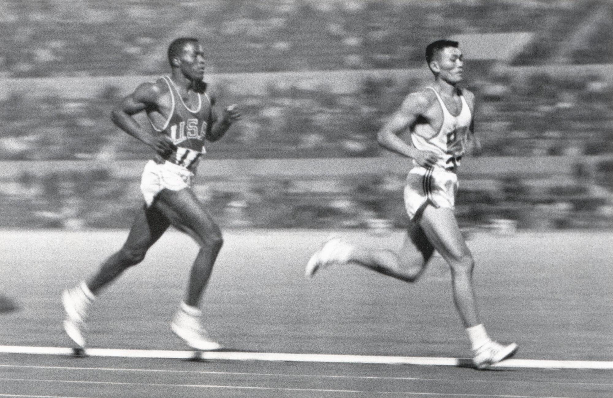 Rafer Johnson of the United States competes against Yang Chuan-kwang of China in the 1,500-meters portion of the decathlon.