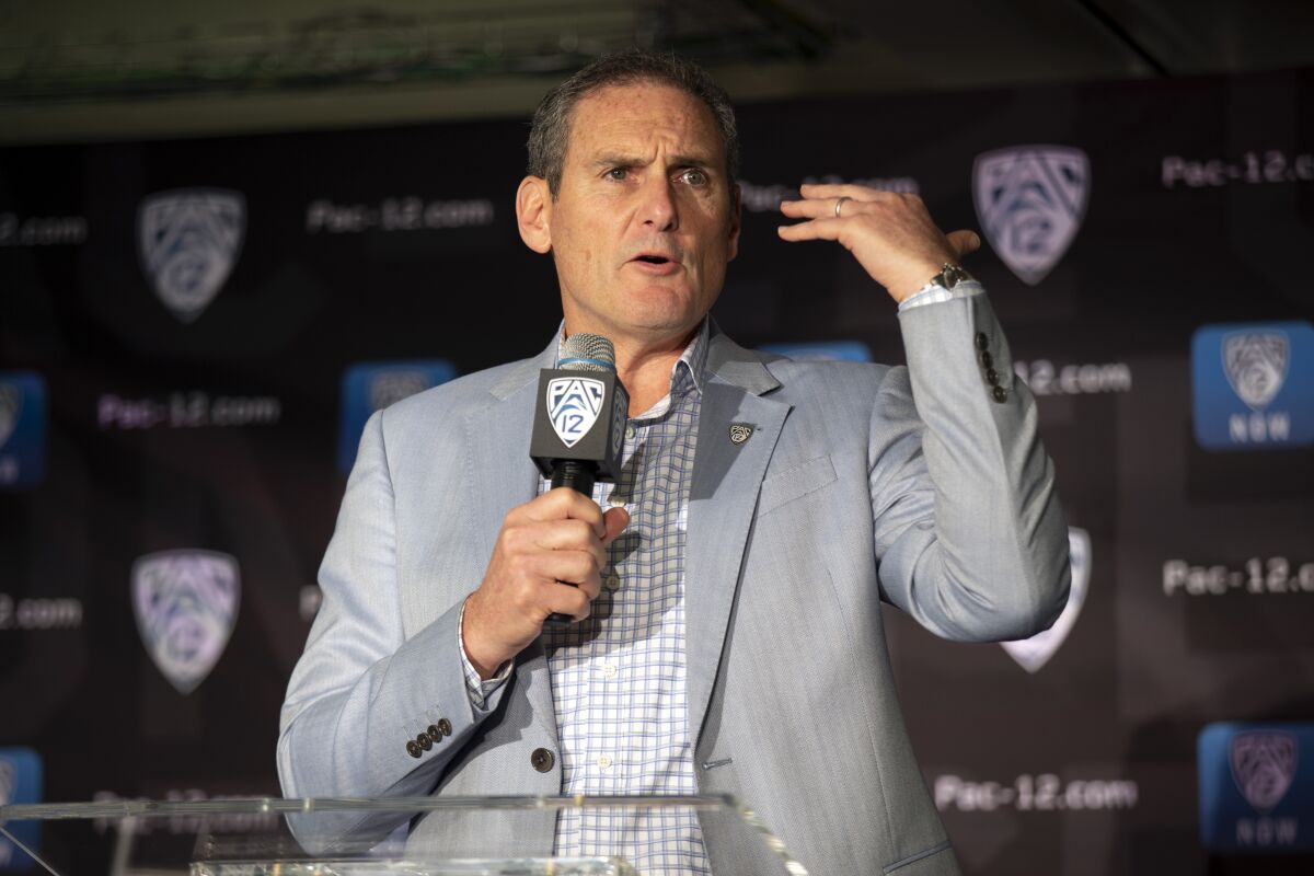 In this Oct. 8, 2019, file photo, commissioner Larry Scott speaks during the Pac-12 college basketball media day in San Francisco.  