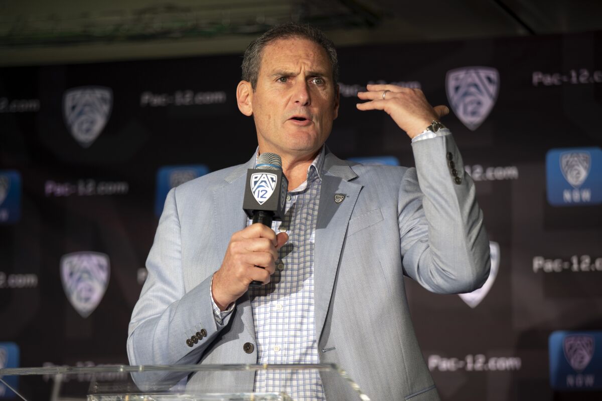 In this Oct. 8, 2019, file photo, commissioner Larry Scott speaks during the Pac-12 college basketball media day in San Francisco.