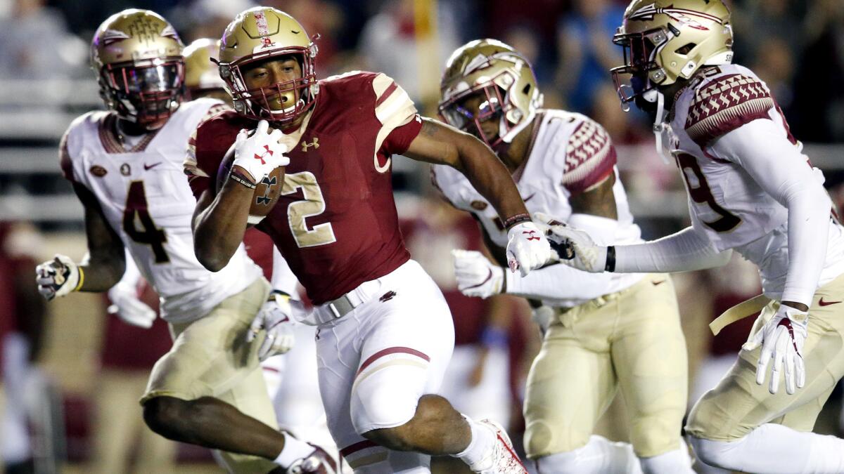Boston College running back A.J. Dillon (2) breaks into the Florida State secondary during a run in the first half Friday.