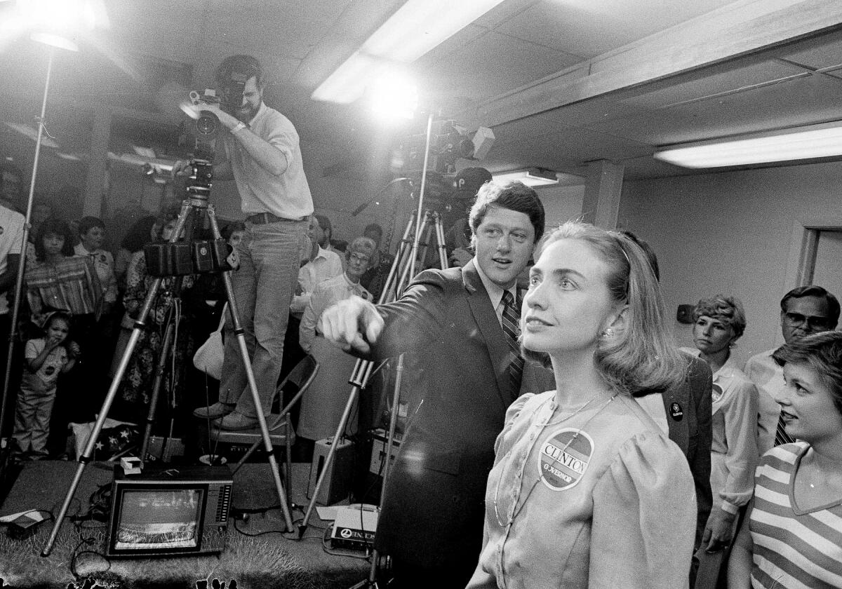 Former Arkansas Governor Bill Clinton, center, and his wife, Hillary Rodham Clinton, foreground, take their places before a press conference at Clinton election headquarters in Little Rock, Ark., May 25, 1982.