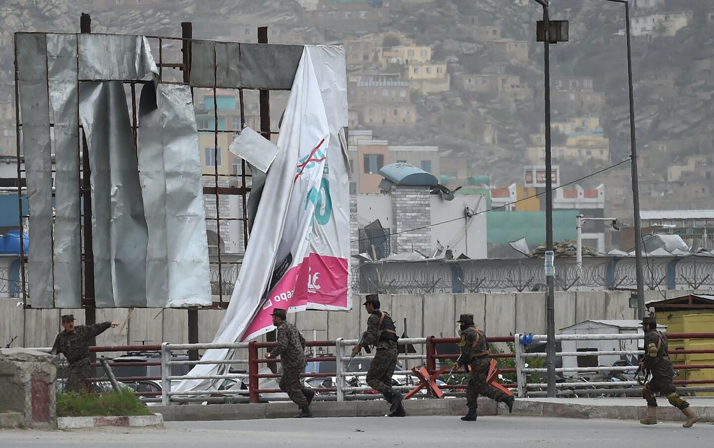 Afghan security personnel arrive after a car bomb attack in Kabul.