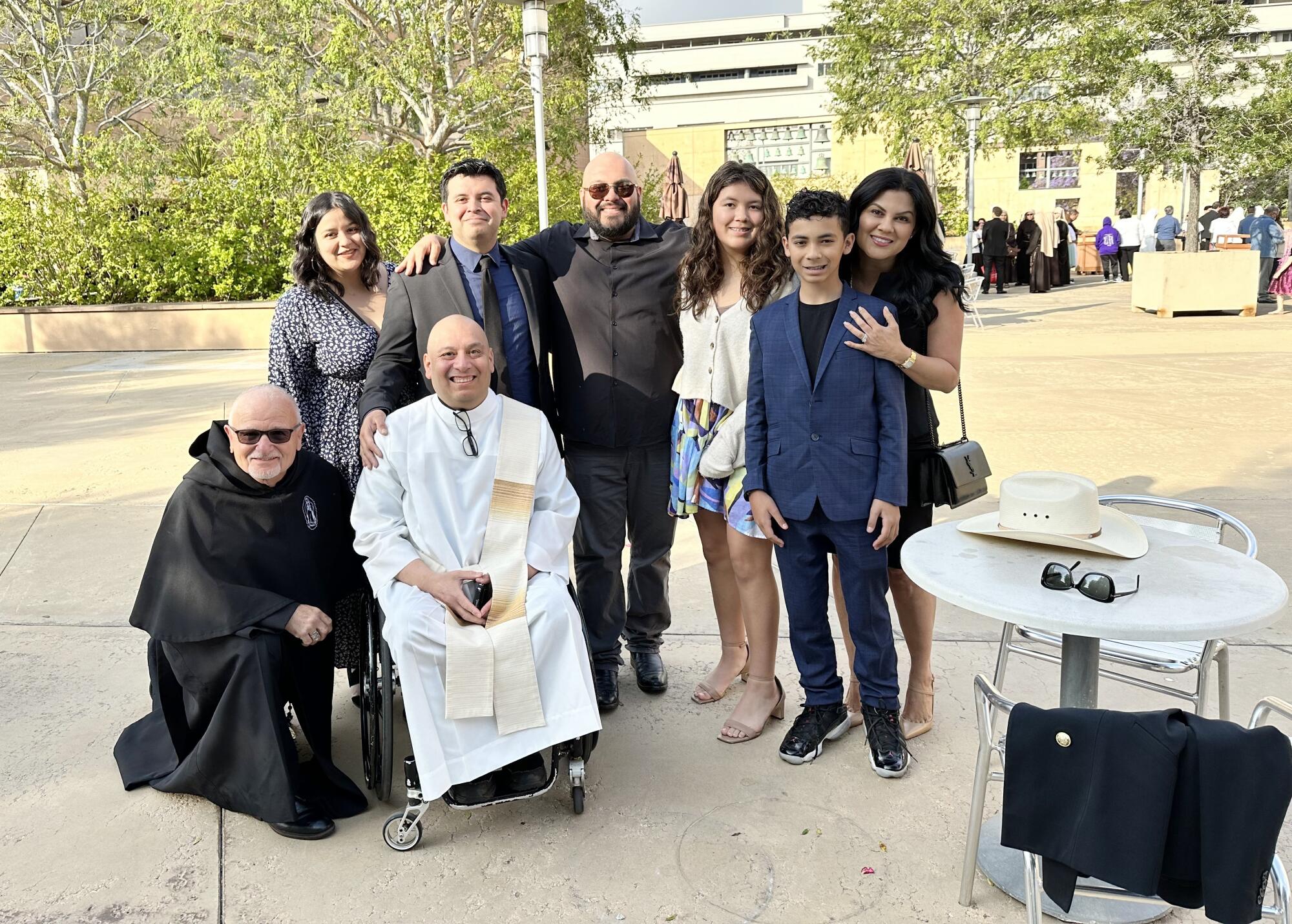 The family gathers for a photo after Father Cesar Galan's ordination in 2023.
