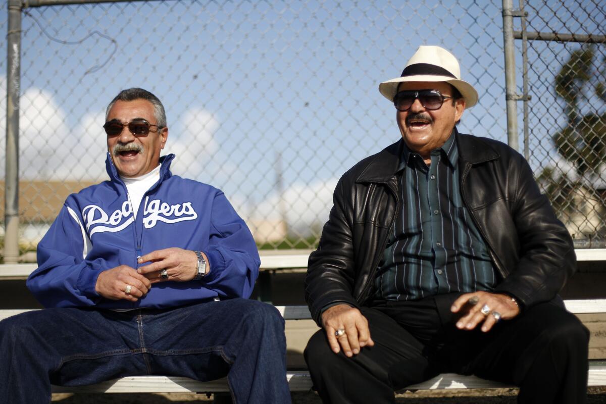 Former Dodgers pitcher Bobby Castillo, left, and longtime team scout Mike Brito chat in March 2011.
