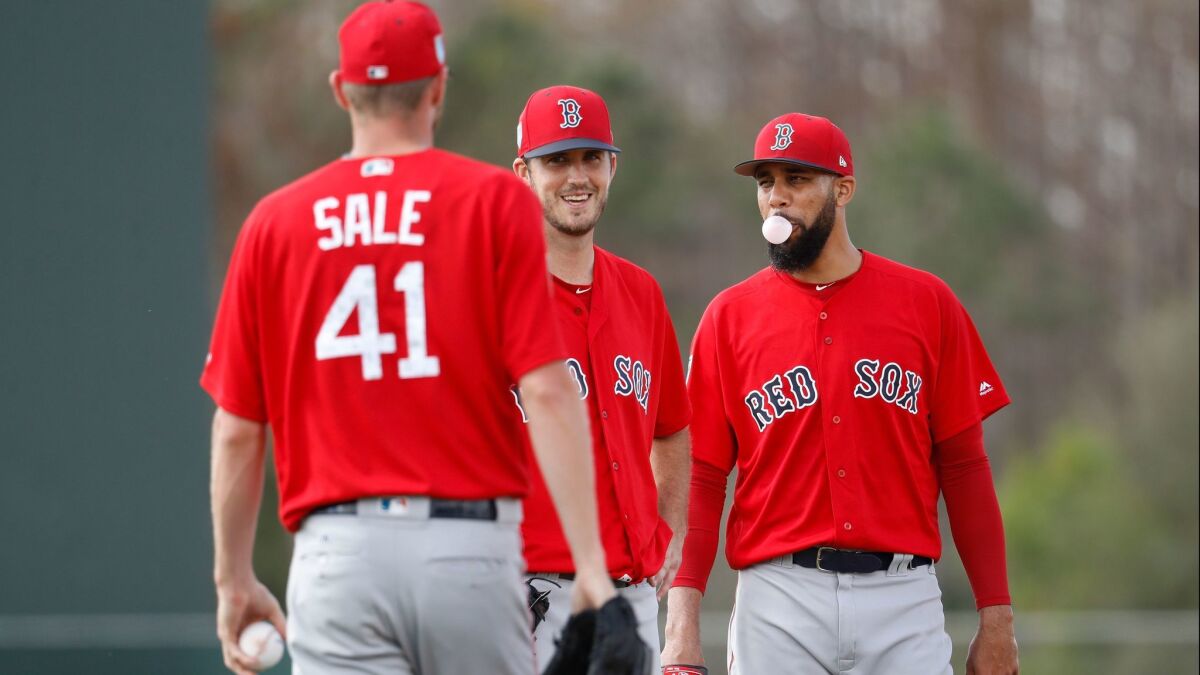 From left, Boston Red Sox starting pitchers Chris Sale (41), Drew Pomeranz, center, and David Price, right, wait for their turns as they practice drills during baseball spring training, Wednesday, Feb. 14, 2018, in Fort Myers, Fla.