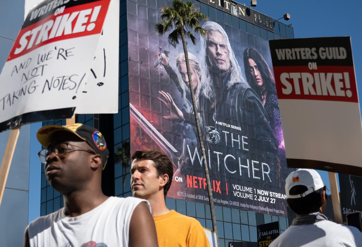 A picket line with a Netflix billboard in the background