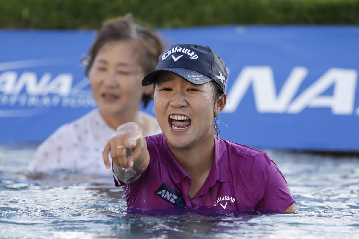 Lydia Ko reacts after winning the LPGA Tour ANA Inspiration and jumping into Champions Lake, or "Poppie's Pond," at Mission Hills Country Club.