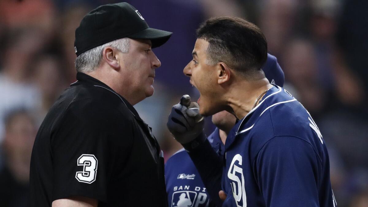 San Diego Padres' Manny Machado yells at home plate umpire Bill Welke after being called out on strikes in the fifth inning of a game against the Colorado Rockies on Saturday in Denver.