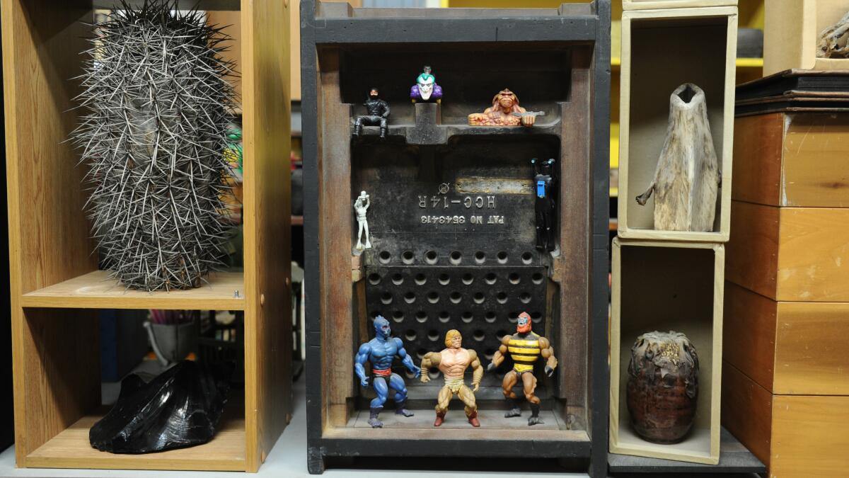 At center, an assemblage by Shiokava is crafted from an old machine mold and found toys.