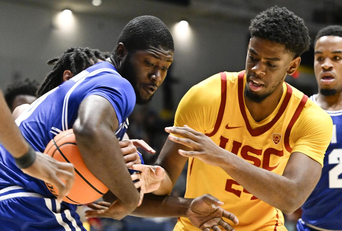 USC forward Joshua Morgan (24) and Seton Hall guard Dylan Addae-Wusu try to grab a loose ball during the first half Thursday.