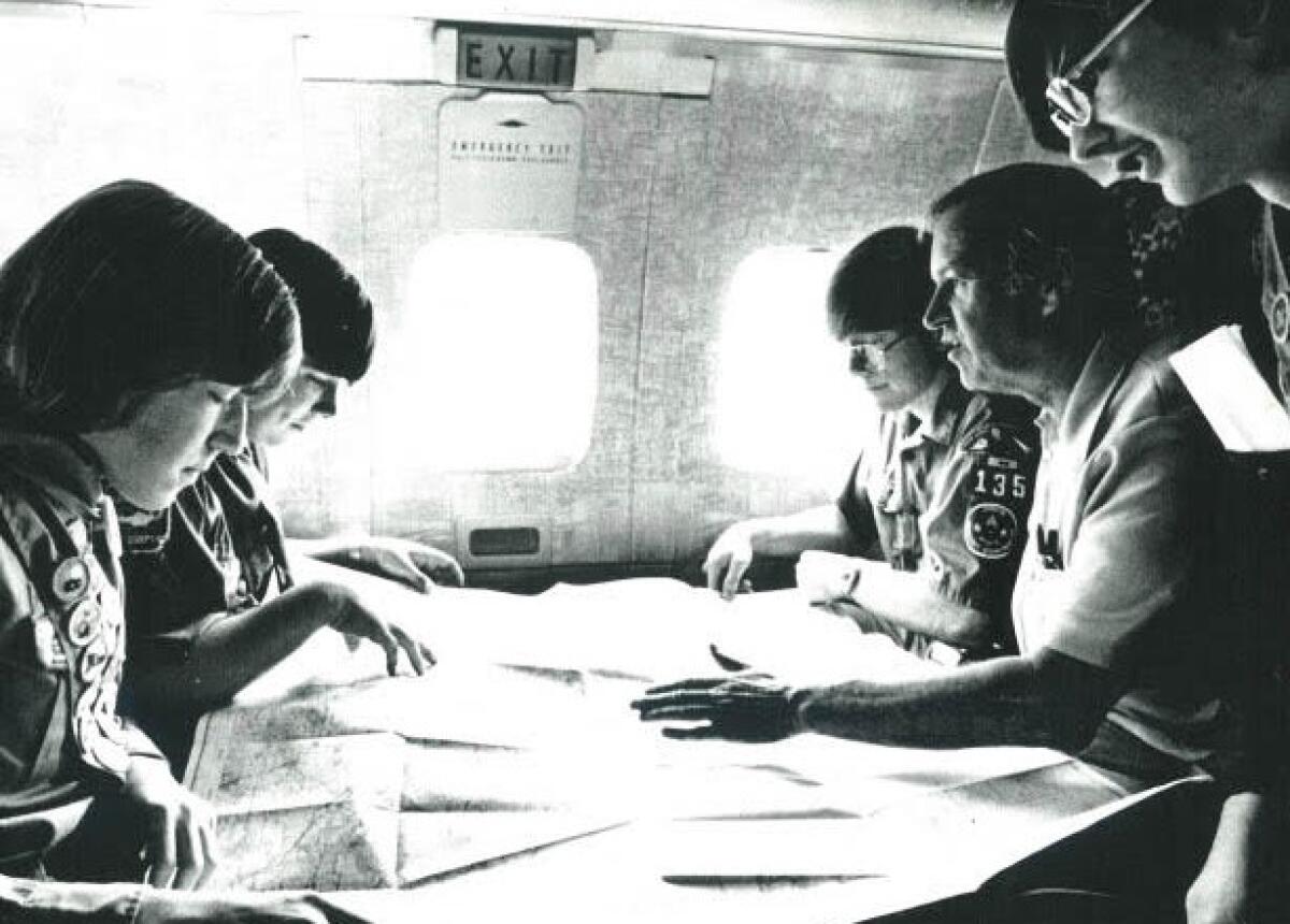 Eagle Scouts look over aviation charts and discuss the Flight of the Eagles.
