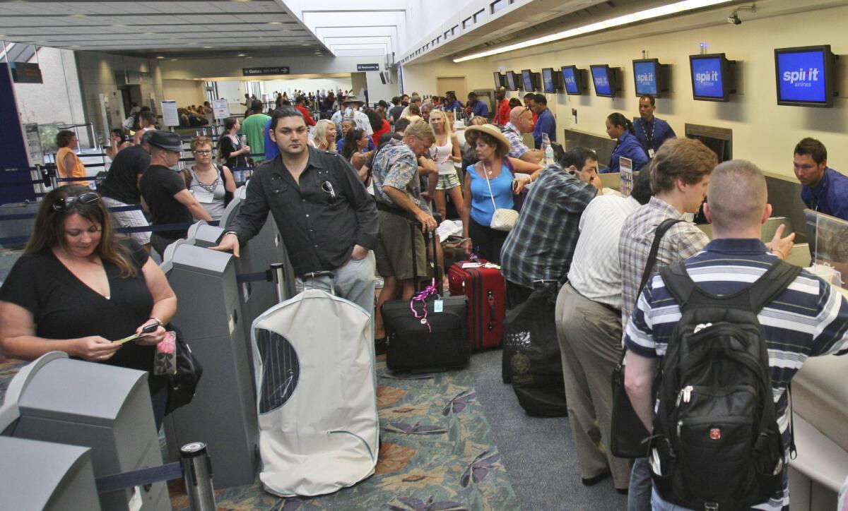 Passengers line up at the Spirit Airlines counter at Fort Lauderdale-Hollywood International Airport in Florida. Spirit Airlines collects 38% of its total revenues from passenger fees, the biggest percentage of any carrier, according to a new study.