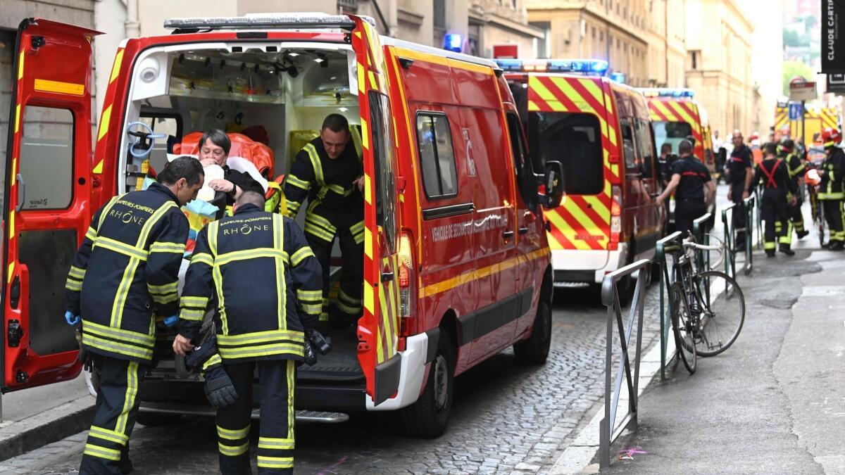 Emergency workers attend to an injured person after a blast on a street in Lyon, France, on May 24.