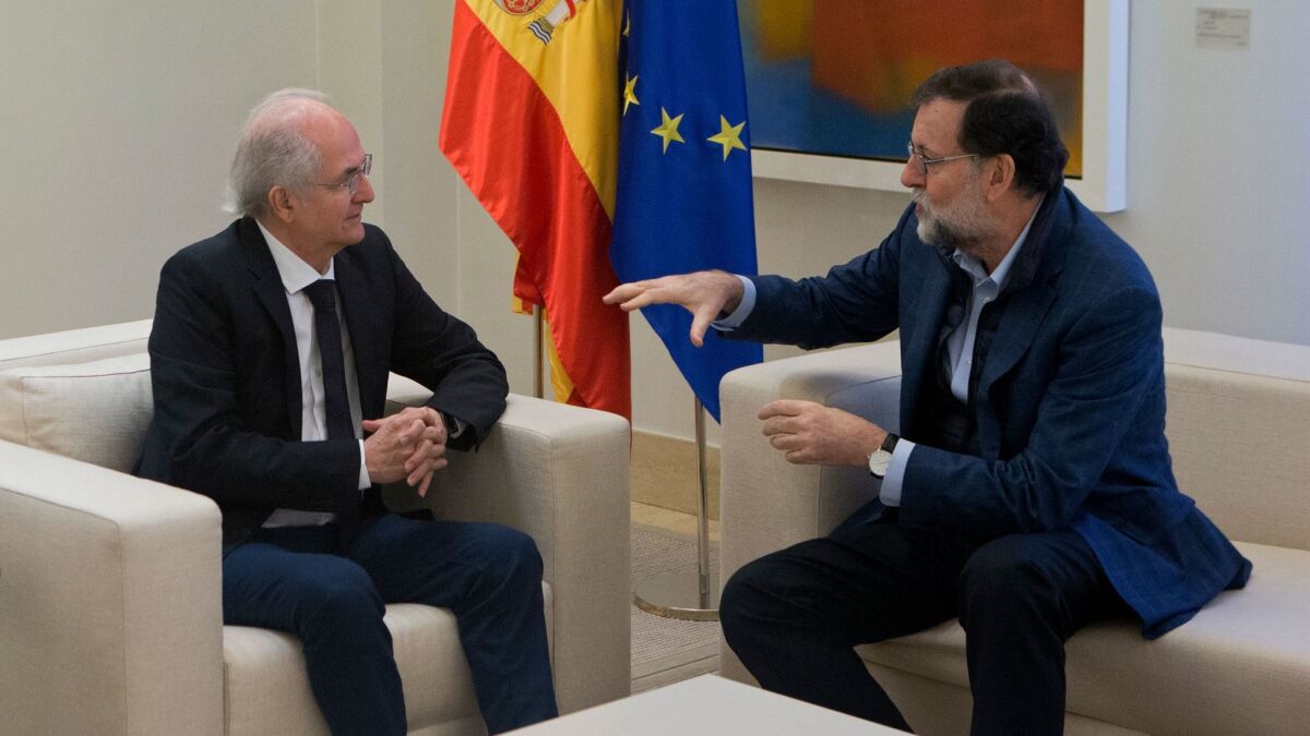 Former Caracas Mayor Antonio Ledezma, left, sits with Spain's Prime Minister Mariano Rajoy during a meeting at the Moncloa Palace in Madrid, Spain, on Nov. 18, 2017.