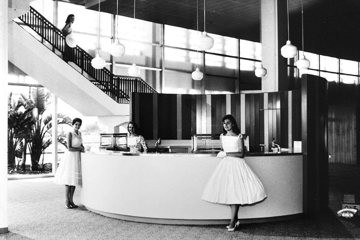 A woman stands at a counter inside the Santa Monica Civic Auditorium.