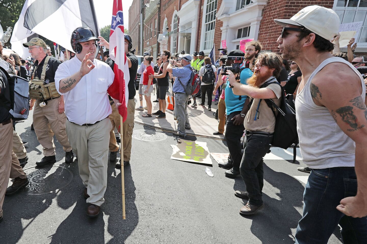 Hundreds of white nationalists, neo-Nazis and members of the "alt-right" are confronted by counter-protesters as they march down East Market Street toward Lee Park during the "United the Right" rally in Charlottesville, Va.