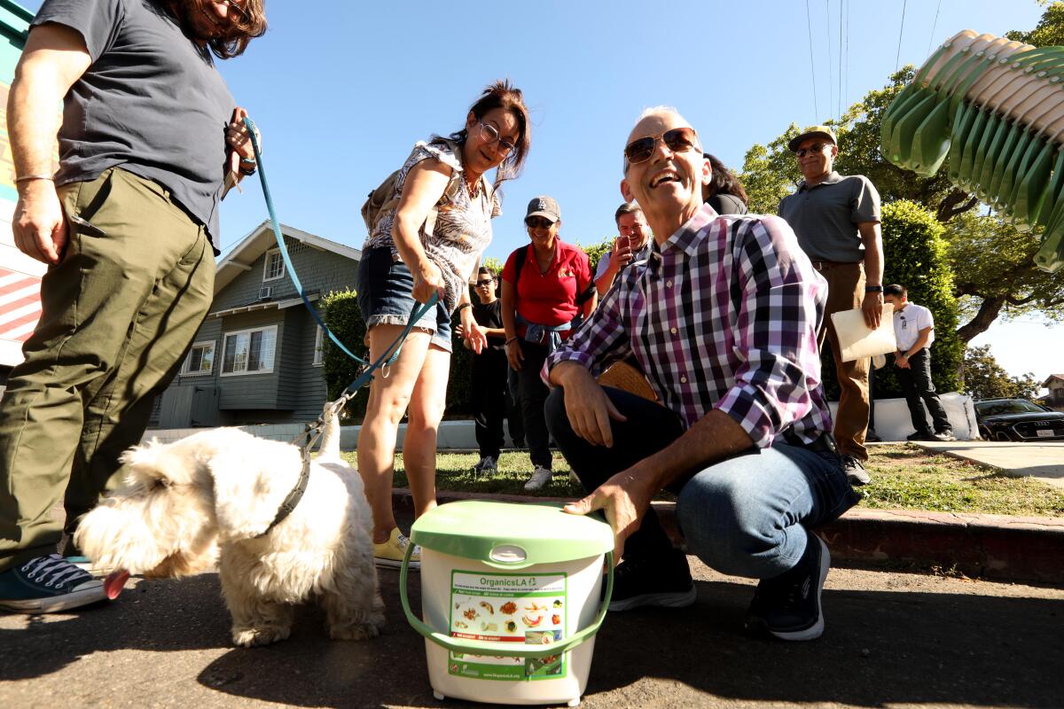 A group of people stand with a dog